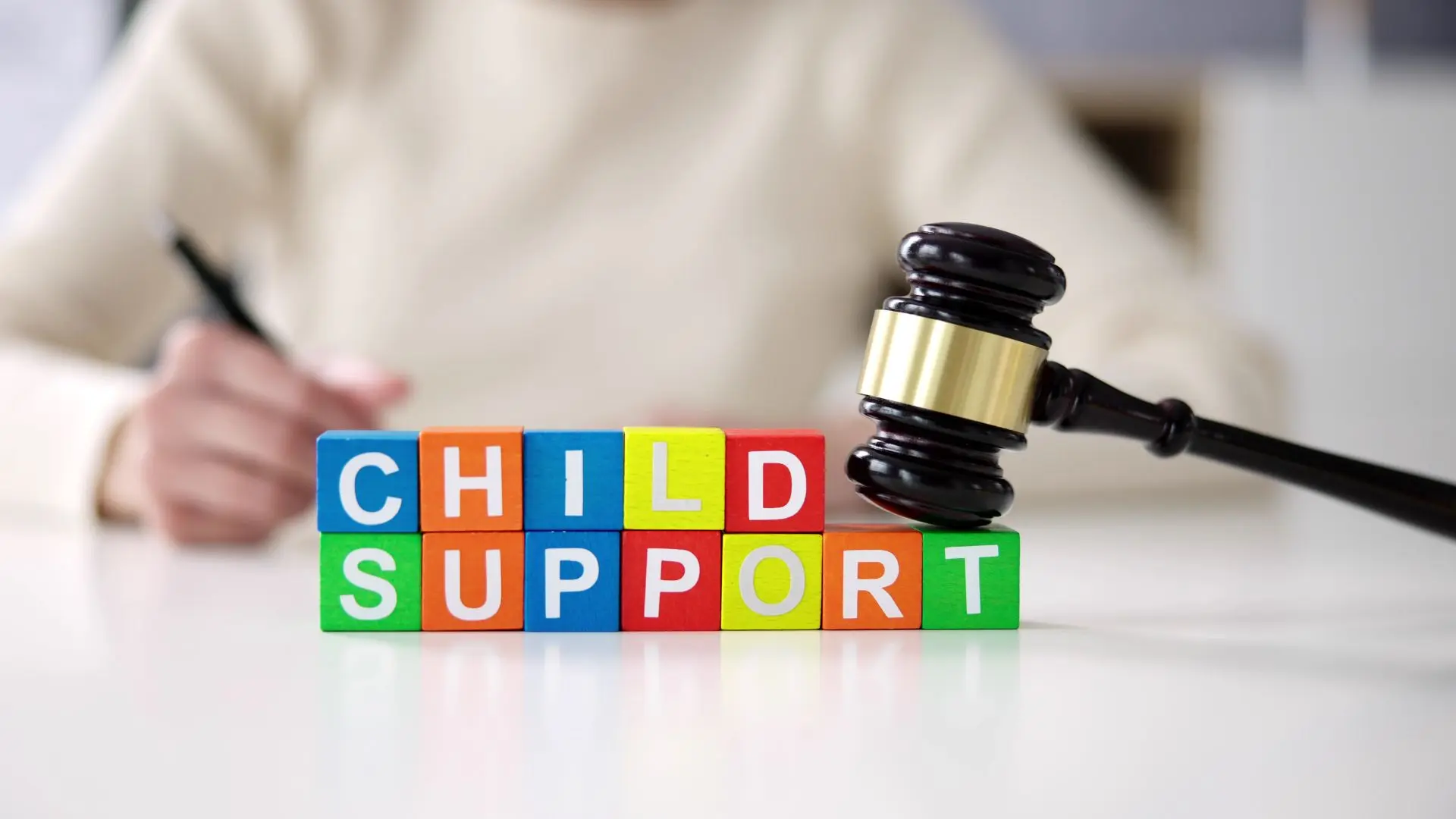 An image of stacked bricks spelling out child support.