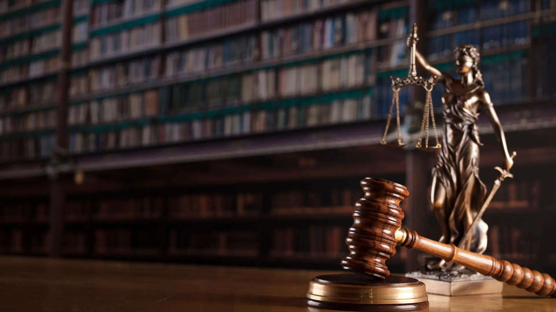 An image of a courtroom library with the scales of justice.