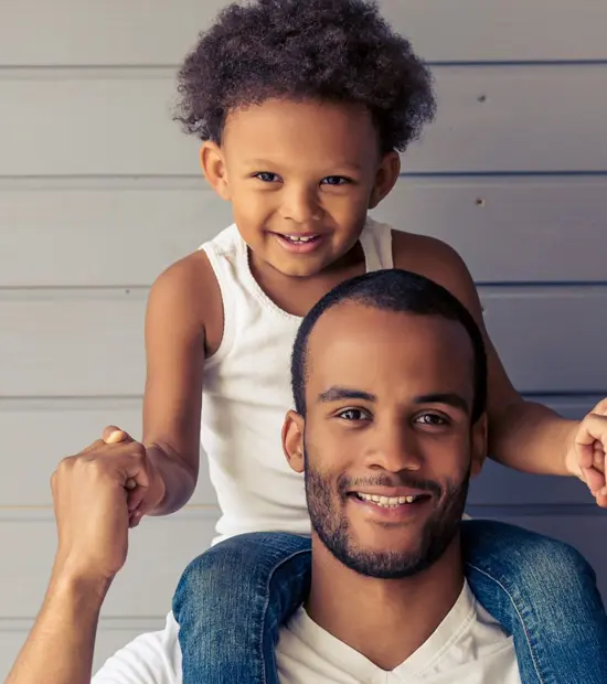 An image of a father with a child on their shoulders illustrating fathers rights