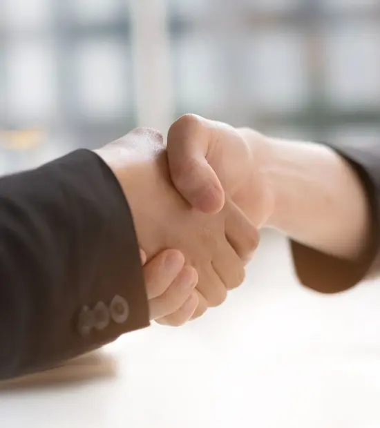 An image of an attorney shaking a clients hand. 